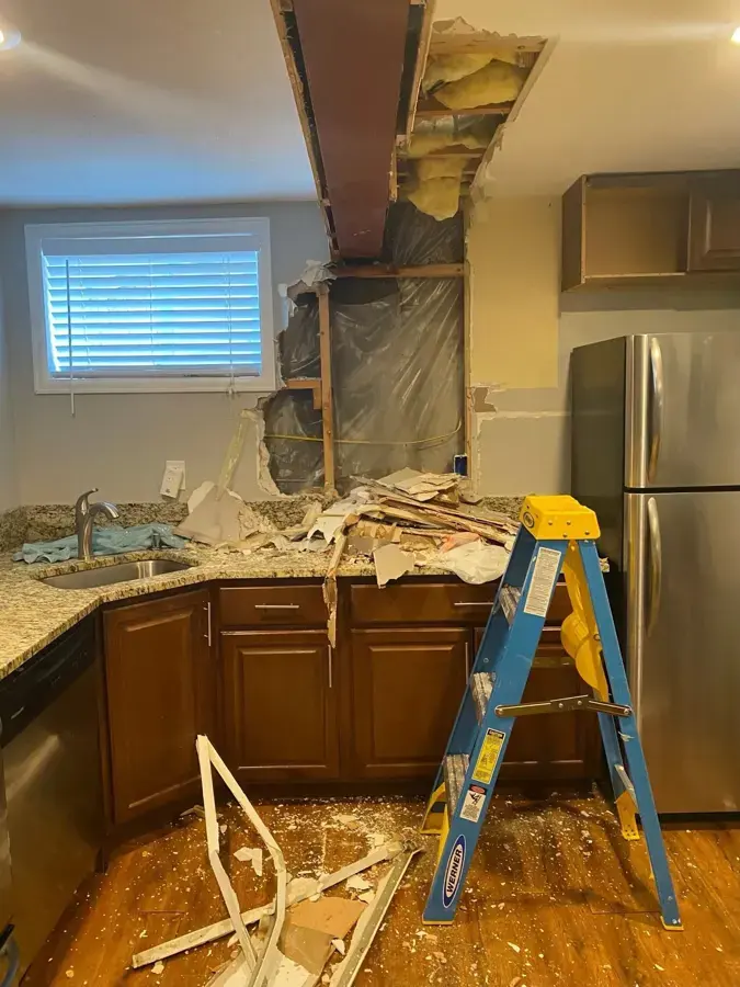 Kitchen ceiling opened to dry a leak from above in a Fontana home
