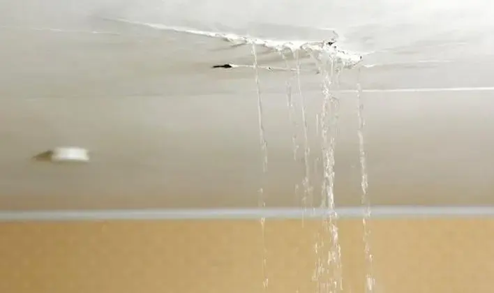 Water running down from a leaking ceiling in a Fontana room
