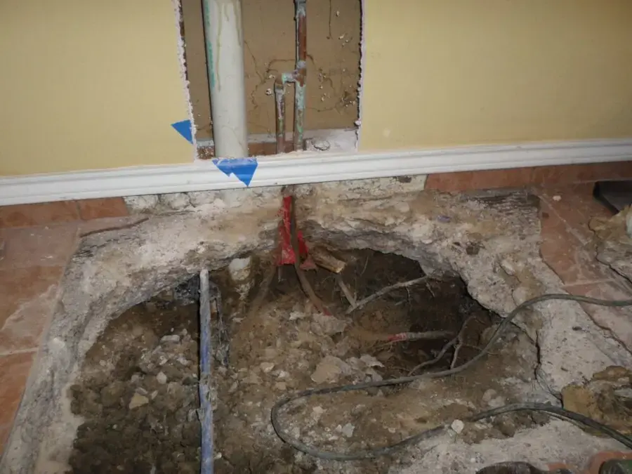 Concrete slab opened to expose a leaking copper supply line in a Fontana home