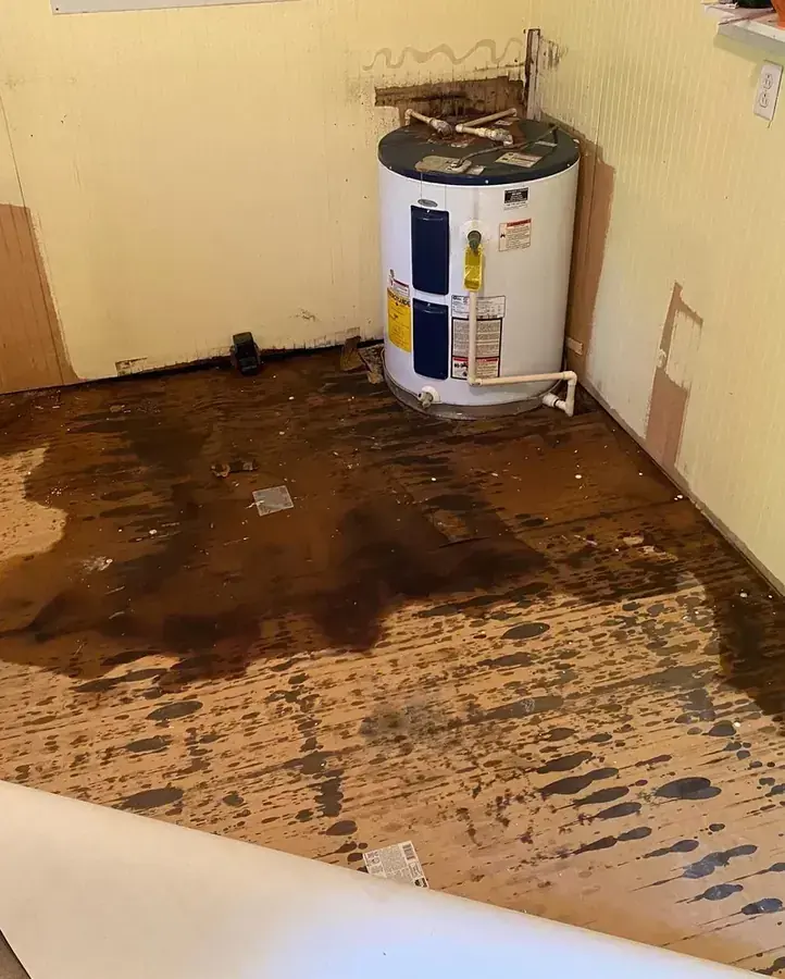 Failed water heater with water spread across the floor of a Fontana closet